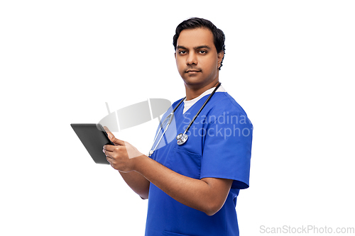 Image of indian doctor or male nurse using tablet computer