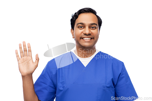 Image of happy indian doctor or male nurse waving hand