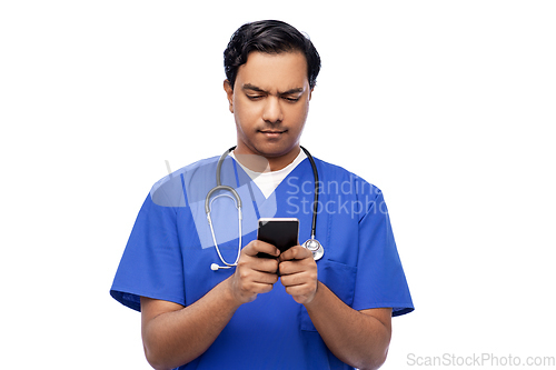 Image of indian doctor or male nurse using smartphone