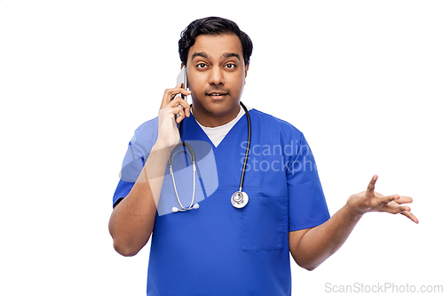 Image of indian doctor or male nurse calling on smartphone