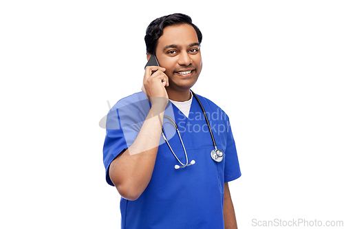 Image of smiling doctor or male nurse calling on smartphone