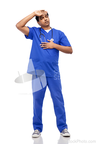Image of stressed doctor or male nurse in blue uniform