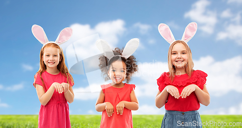 Image of happy girls wearing easter bunny ears headbands