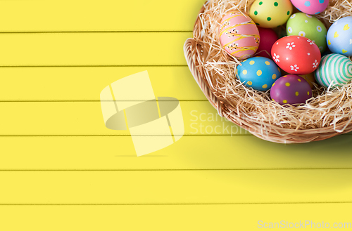 Image of close up of colored easter eggs in basket