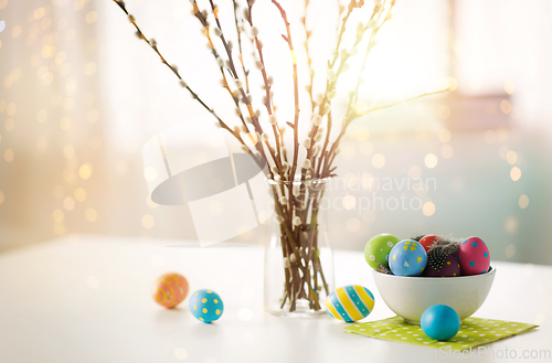 Image of pussy willow branches and colored easter eggs