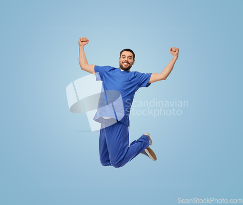 Image of happy smiling doctor or male nurse jumping in air