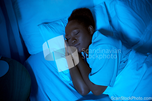 Image of african woman sleeping in bed at home at night