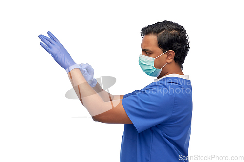 Image of indian male doctor in uniform, mask and gloves