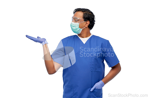Image of indian male doctor in mask holding something