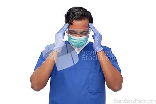 Image of stressed doctor or male nurse having headache