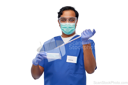 Image of indian scientist in mask with dropper and vaccine