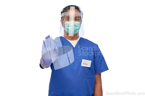 Image of indian male doctor in mask and face shield