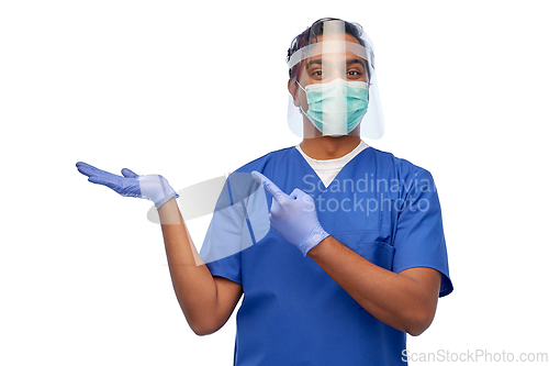 Image of indian male doctor in mask and face shield