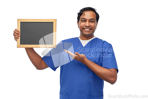 Image of happy indian male doctor or nurse with chalkboard