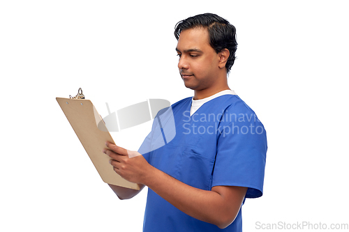 Image of male doctor writing medical report on clipboard