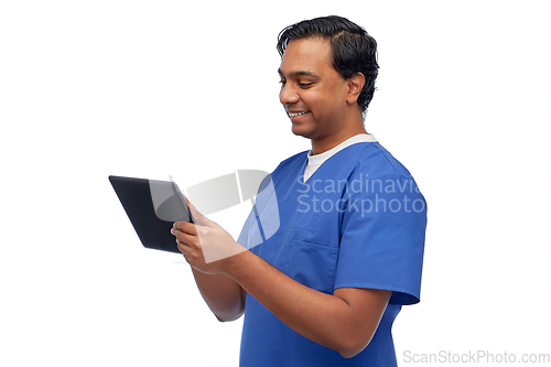 Image of smiling doctor or male nurse using tablet computer