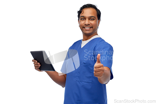 Image of male doctor with tablet pc showing thumbs up