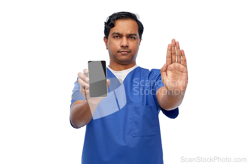 Image of indian male doctor with phone showing stop gesture