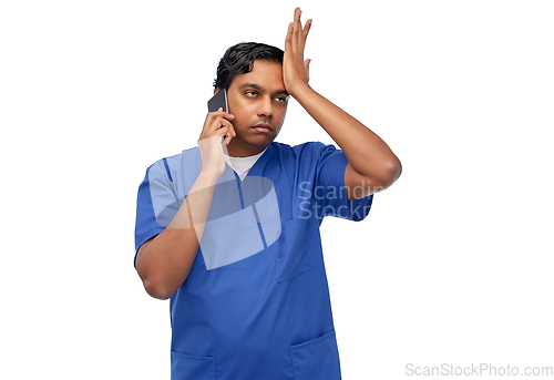 Image of indian doctor or male nurse calling on smartphone