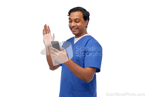 Image of doctor or male nurse having video call on phone