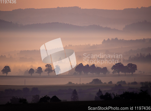 Image of Autumn foggy and misty sunrise landscape