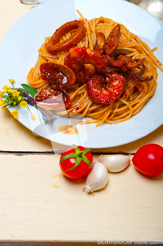 Image of Italian seafood spaghetti pasta on red tomato sauce