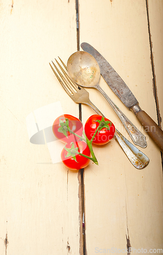 Image of ripe cherry tomatoes over white wood