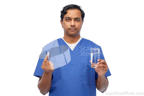 Image of indian doctor with medicine and glass of water