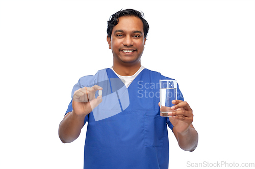 Image of indian doctor with medicine and glass of water