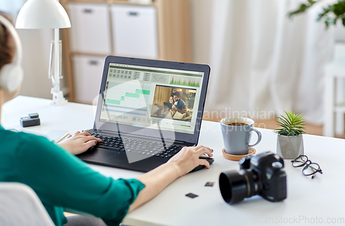 Image of woman with video editor program on laptop at home