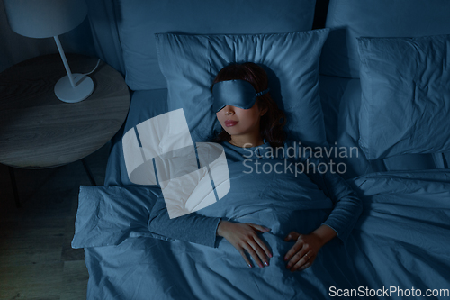 Image of asian woman sleeping in bed at home at night