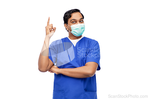 Image of indian male doctor in blue uniform and mask