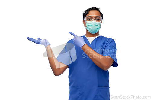 Image of indian male doctor in mask showing something