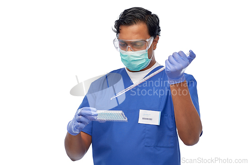 Image of indian scientist in mask with dropper and vaccine