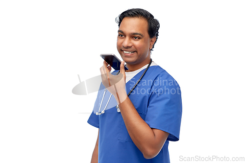 Image of indian male doctor recording voice with smartphone