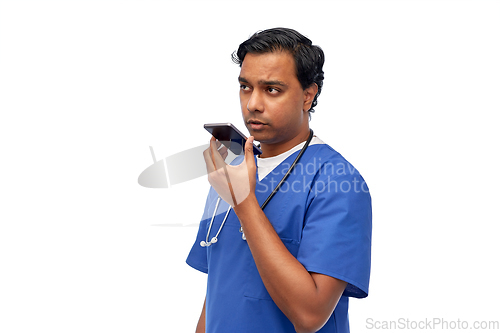 Image of indian male doctor recording voice with smartphone