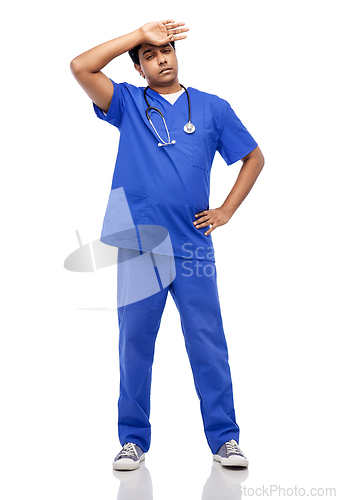 Image of stressed doctor or male nurse in blue uniform