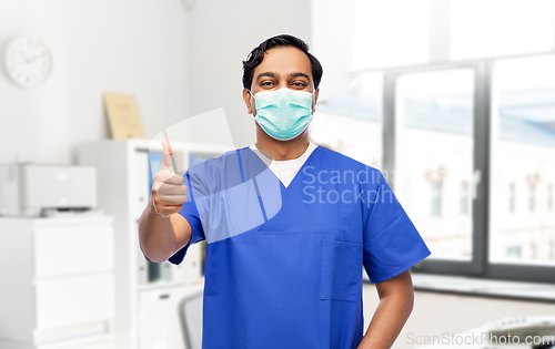 Image of indian male doctor in mask showing thumbs up