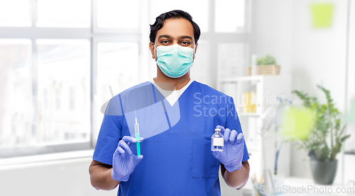 Image of indian doctor in mask with syringe and medicine