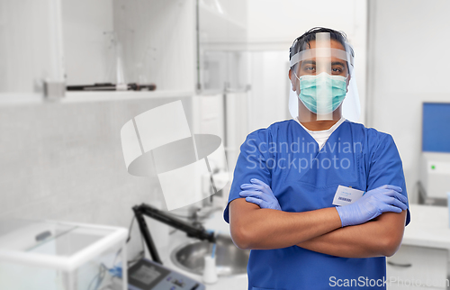 Image of indian male doctor in mask and face shield