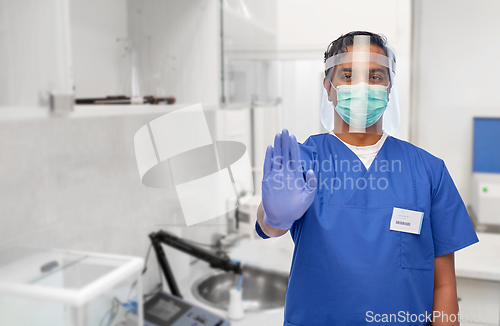 Image of indian male doctor in mask and face shield