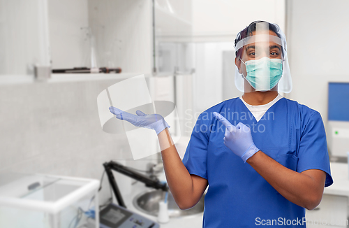 Image of indian male doctor in mask and face shield