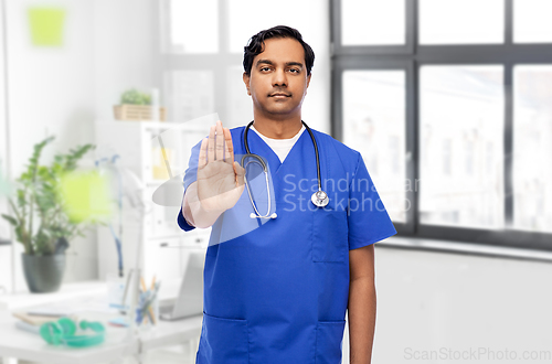 Image of indian doctor or male nurse showing stop gesture