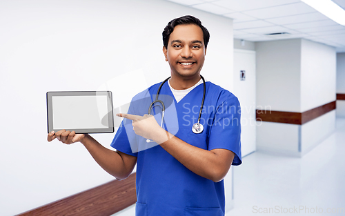 Image of happy doctor or male nurse showing tablet computer