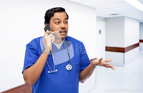 Image of indian doctor or male nurse calling on smartphone