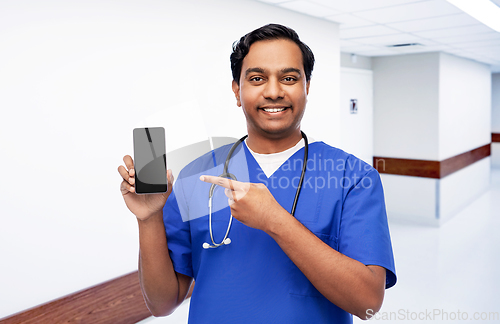 Image of happy indian doctor or male nurse with smartphone