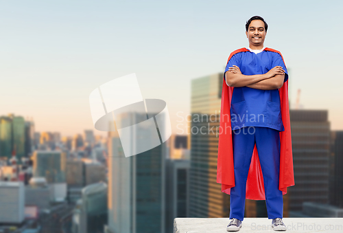 Image of doctor or male nurse in superhero cape in city