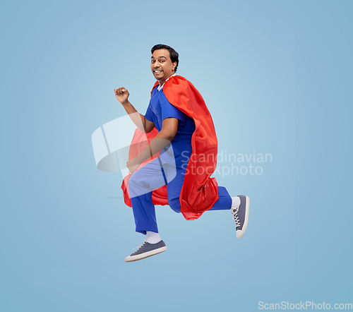 Image of doctor or male nurse in superhero cape jumping