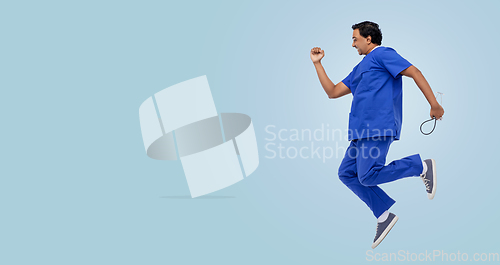 Image of doctor or male nurse with stethoscope jumping