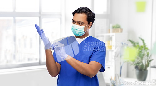 Image of indian male doctor in uniform, mask and gloves